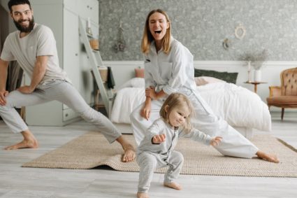 A joyful family engaging in morning stretches together, fostering a fun and healthy routine.