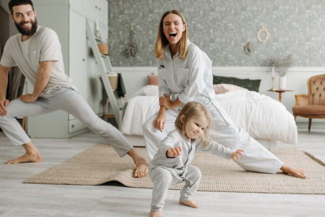 A joyful family engaging in morning stretches together, fostering a fun and healthy routine.